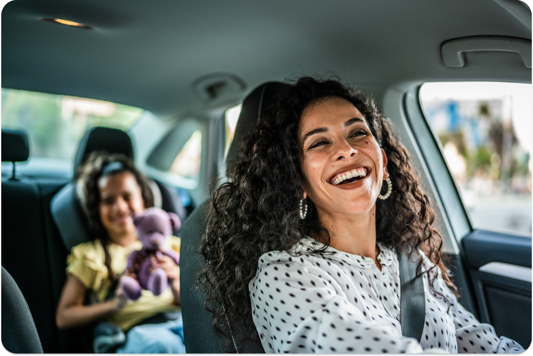 happy mom with daughter in car